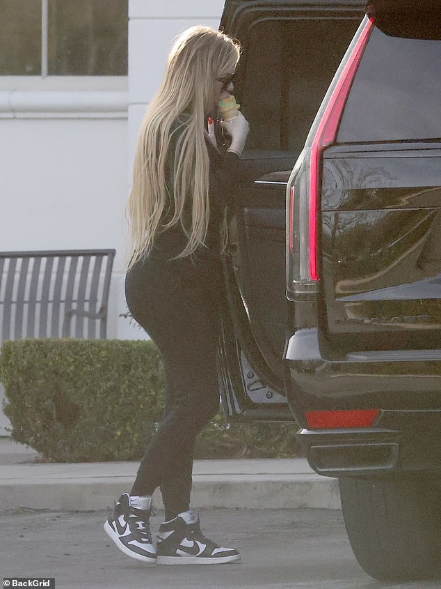Khloe had on a long-sleeve top, skinny jeans and a pair of Nike sneakers