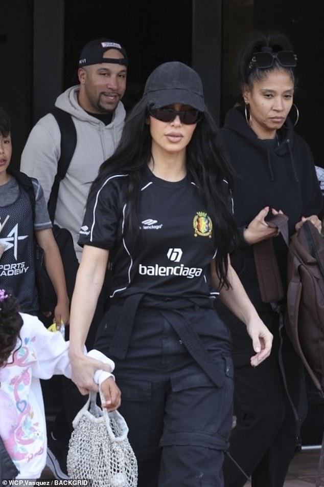 Kim accessorized with a black suede baseball cap with matching sunglasses from the Parisian fashion brand