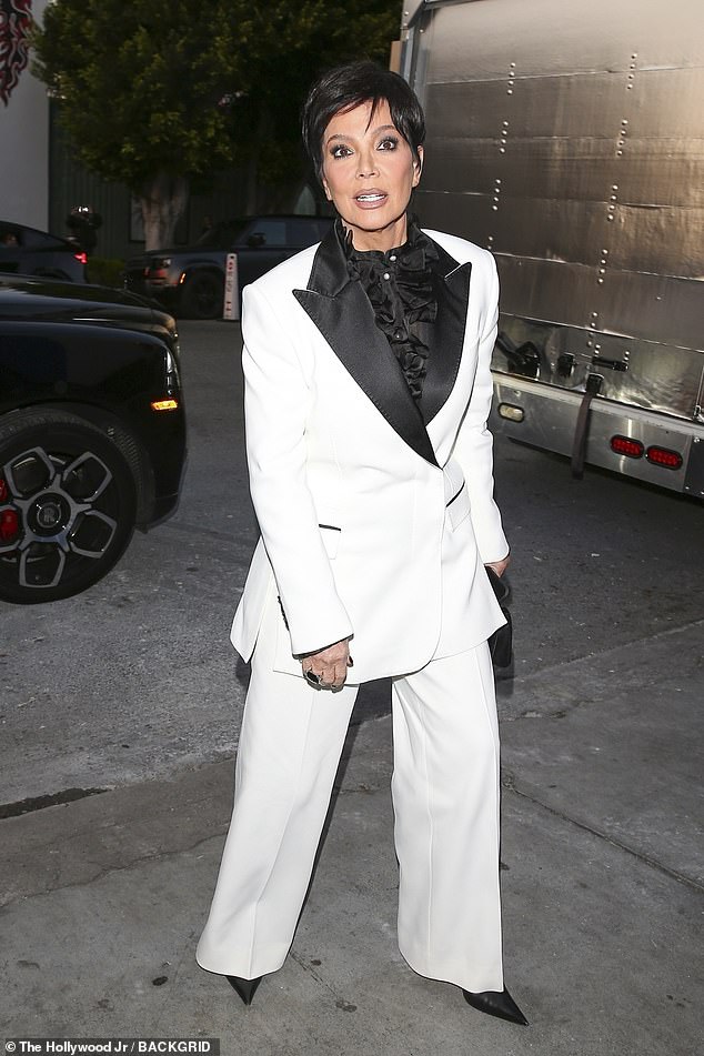 Kris looked sharp in a 70s-inspired white suit with black dagger lapels on the jacket and a ruffled black blouse underneath