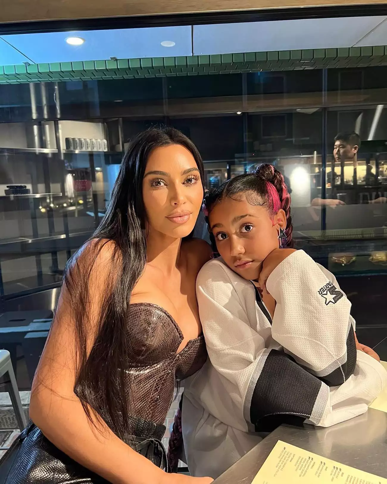 Kim Kardashian and North West Posed at Table North Leaning Into Kim Soft Smiles