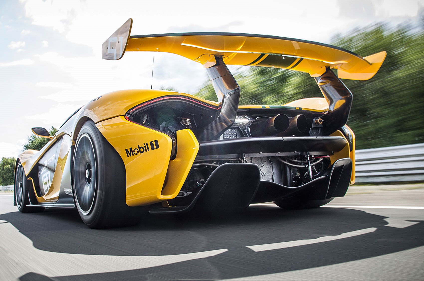 Rear view of yellow McLaren P1 GTR on track