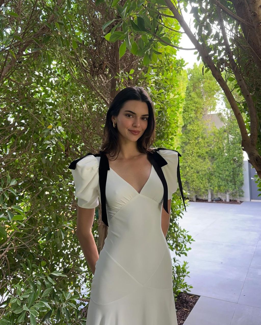 Kendall Jenner in white gown with black velvet bows