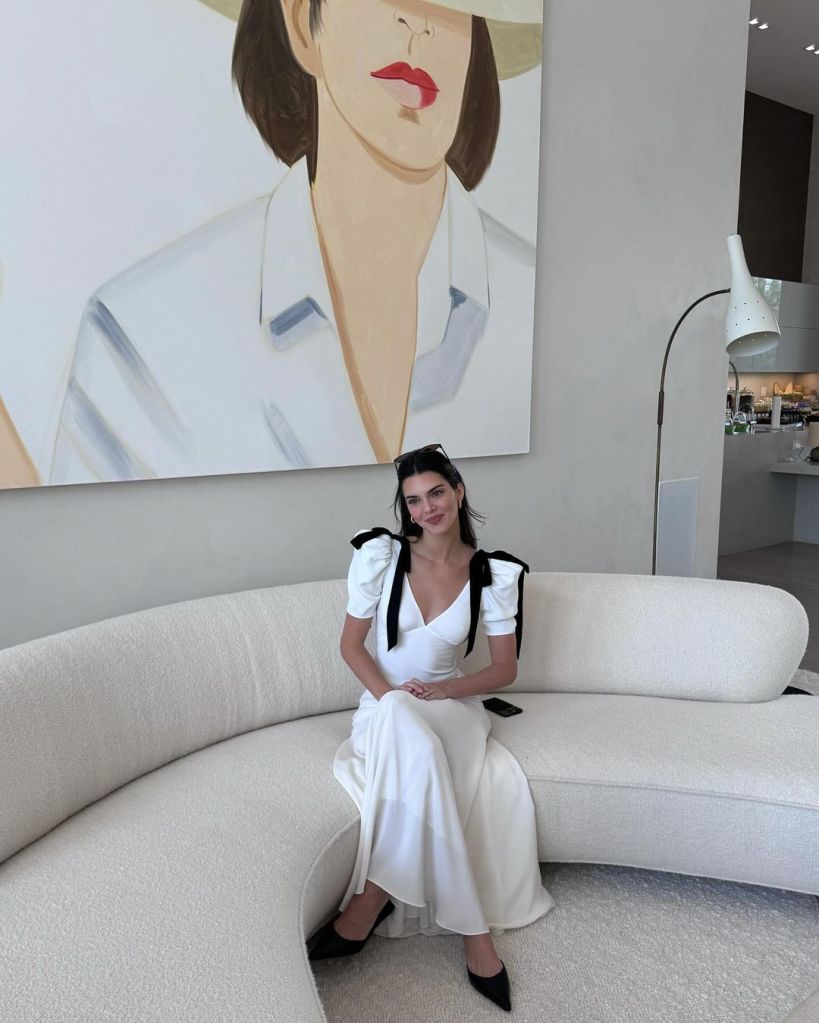 Kendall Jenner sitting on couch in white silk dress on Easter.