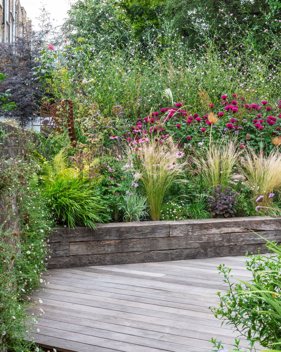 a wooden walkway in a garden