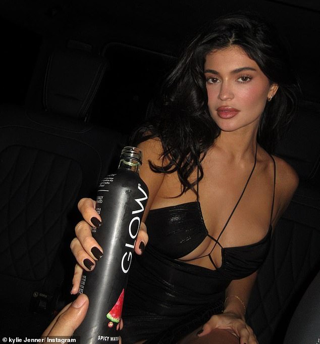 Stunning: Kylie Jenner put on a busty display in a plunging mini dress as she celebrated her new partnership with Glow Beverages
