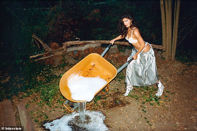 Working for the weekend: She donned a sexy look while pushing a wheelbarrow