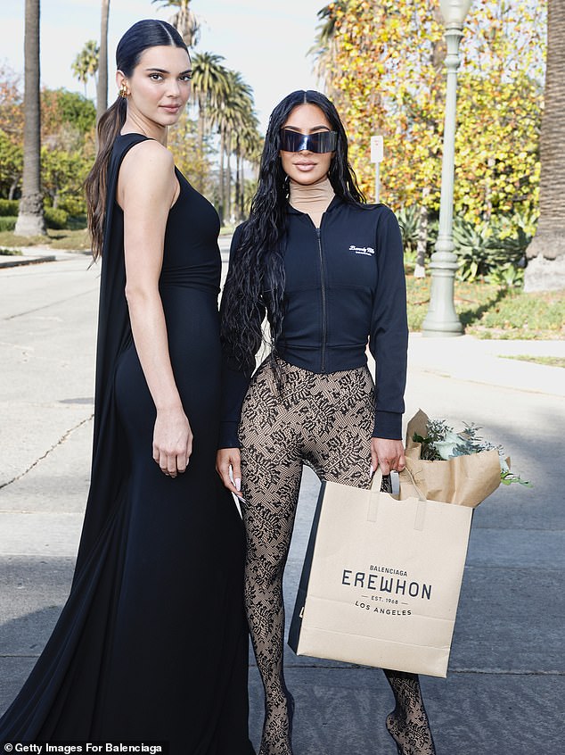 Kim Kardashian and Kendall Jenner showed their love for Balenciaga as they posed together at the brand's show in Los Angeles on Saturday