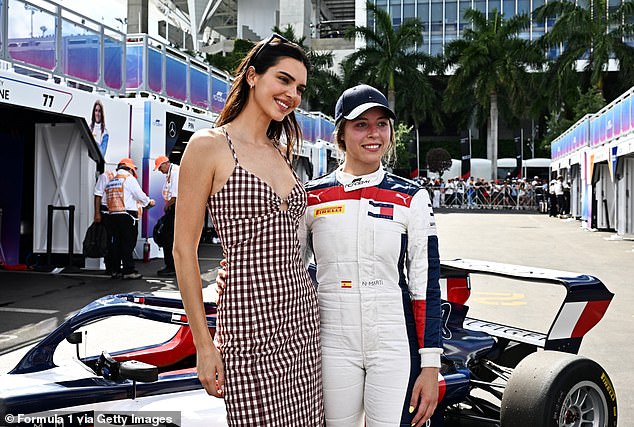 The model posed with Nerea Marti of Spain and Campos Racing in the Paddock after a practice round
