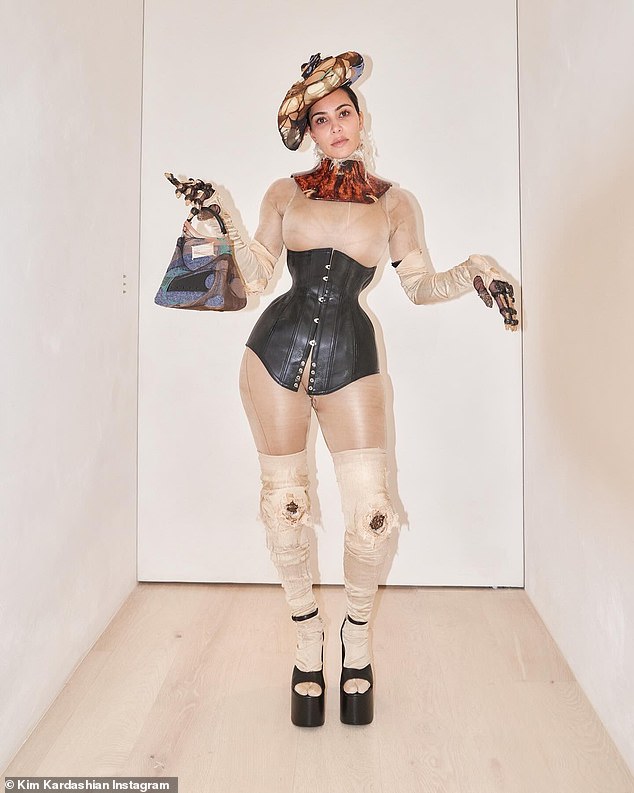Kim Kardashian is BACK cinching her waist in a corset after controversial Met Gala look - as she calls herself a 'broken doll' wearing Maison Margiela