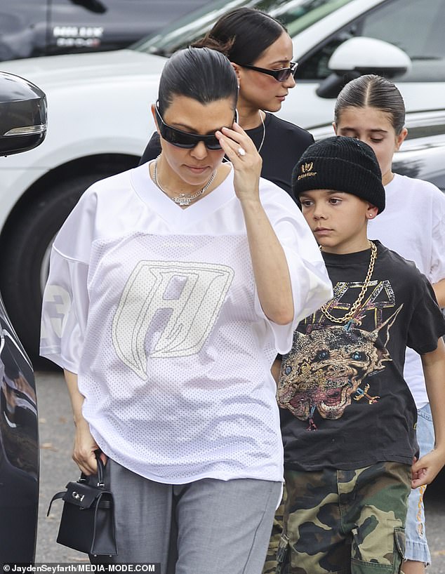 Kourtney pictured with her children Penelope, 11, and Reign, nine, in February 2024