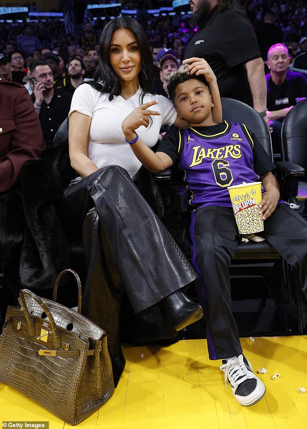 Kim pictured with her son Saint, eight, in March 2024