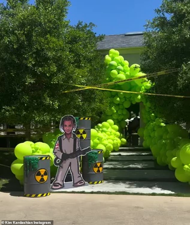 She documented a tour of the soiree, starting with a glimpse of the green slime-themed decorations adorning the entrance to her home