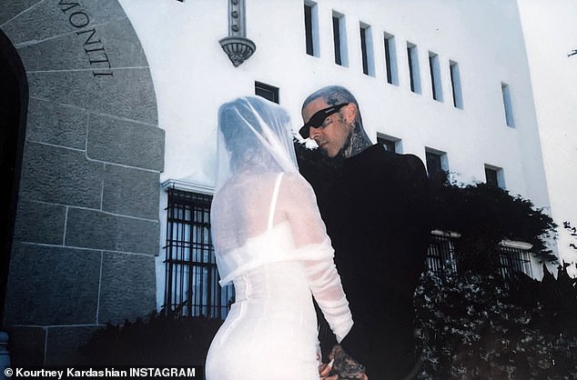 She paired the ensemble with a shoulder-length veil as well as sheer, opera-length gloves for a final touch. Barker wore an all-black outfit and a pair of fashionable black shades for the legal ceremony