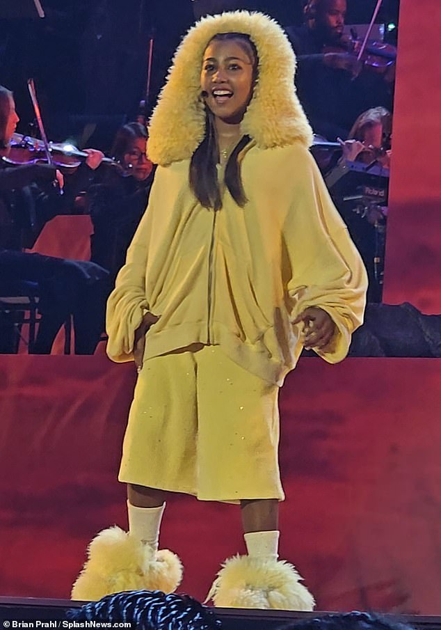 Exuding confidence, the pre-teen sported a yellow hoodie and matching shorts with a fuzzy hood and slippers