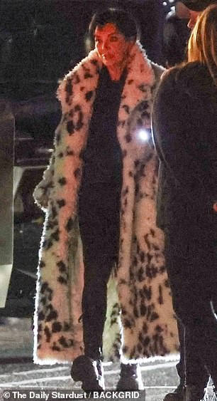 She stepped out in an ankle-length animal print coat