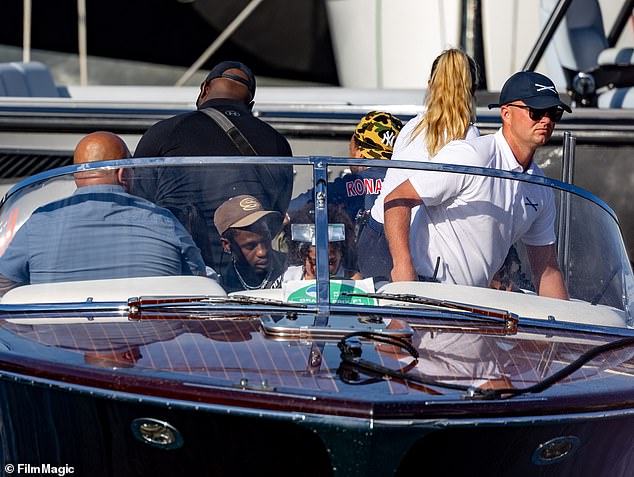 Travis and his daughter were spotted sitting towards the front of a sleek, dark brown boat on the water in Monte-Carlo