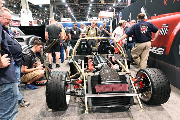The Factory Five team at SEMA, showing the F9R space frame chassis with a massive 9.5-liter LS V12 engine installed