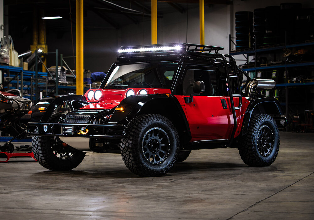 Red and black SCG BOOT parked in garage with lights on