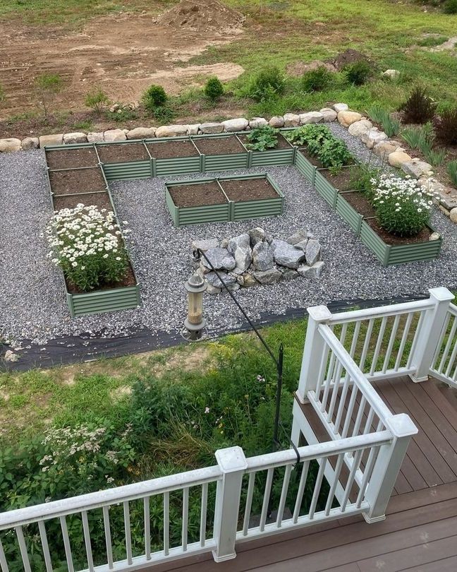 a deck with a stone wall and a garden