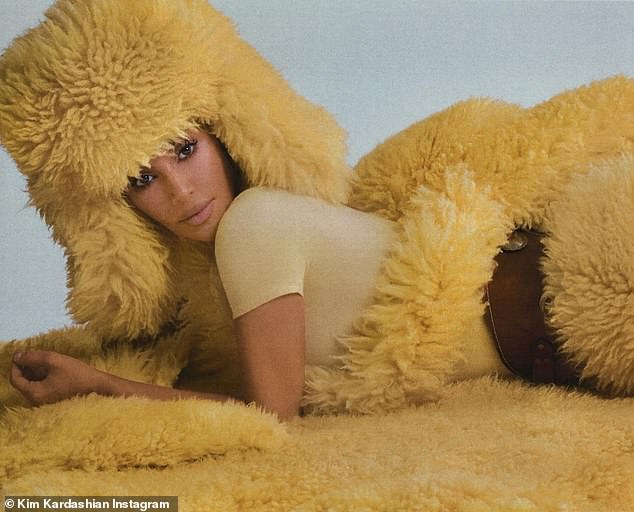 Kim posed suggestively in other photos, including one in which she was lying on her stomach on her coat, as if it was a fur rug