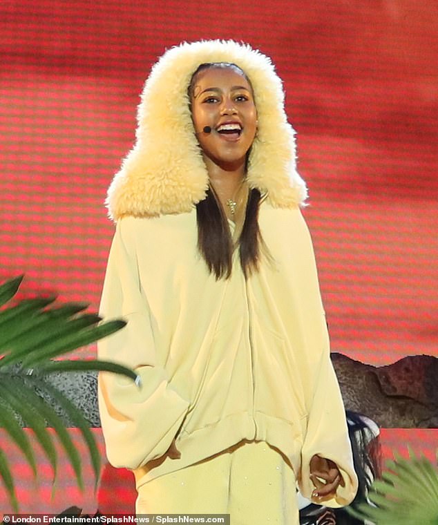 She had on a zip-up yellow hood with a more mane-like hat, along with baggy shorts and fuzzy shoes (pictured at the Hollywood Bowl), which was less complicated than the looks North was photographed in for social media; seen on May 24