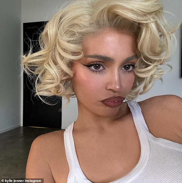 Kylie Jenner shared two photographs of herself on Friday wearing a bright-blonde wig with ringlet curls, reminiscent of Marilyn Monroe' s iconic look