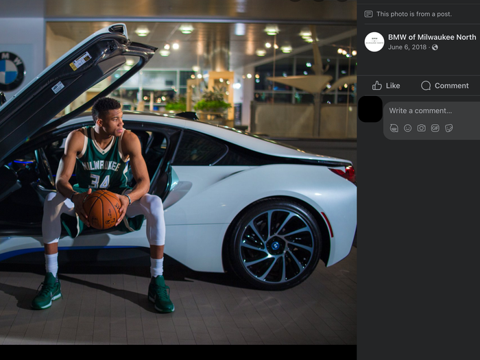 Giannis Antetokounmpo poses with a BMW.