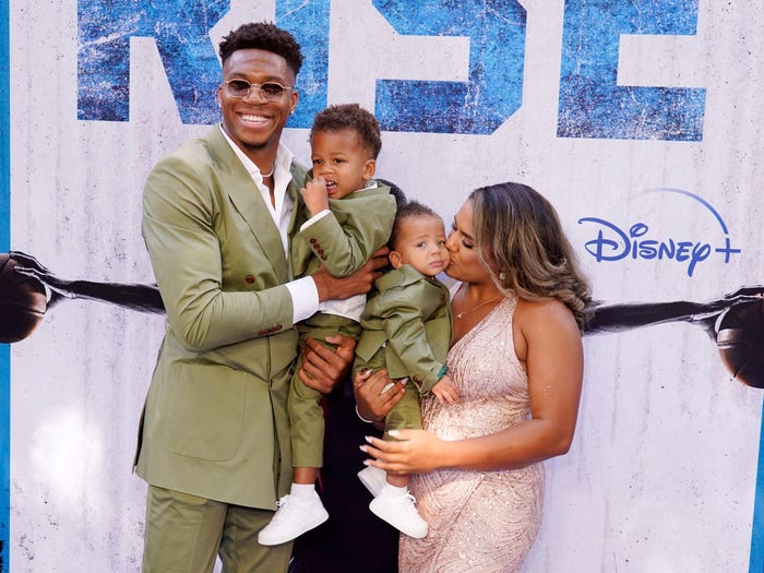 Giannis Antetokounmpo (left) poses with his fiancée, Mariah Riddlesprigger, and their two sons.